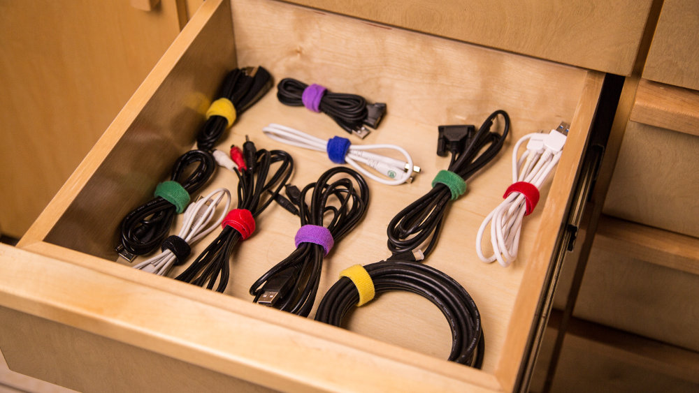 Picture of an open drawer with cords and cables neatly wrapped with eco-friendly cable ties. Good cable management shown.